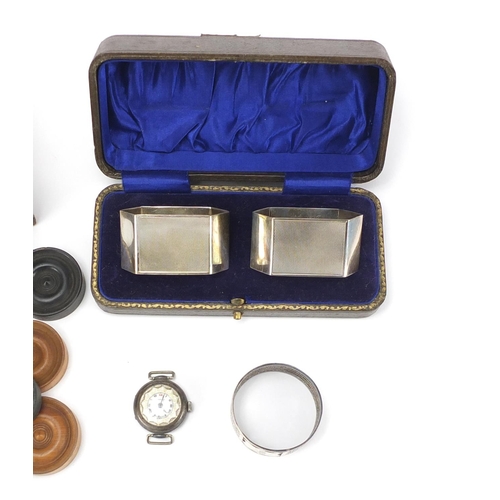 270 - Miscellaneous items comprising boxed pair of silver napkin rings, circular silver napkin, silver lad... 