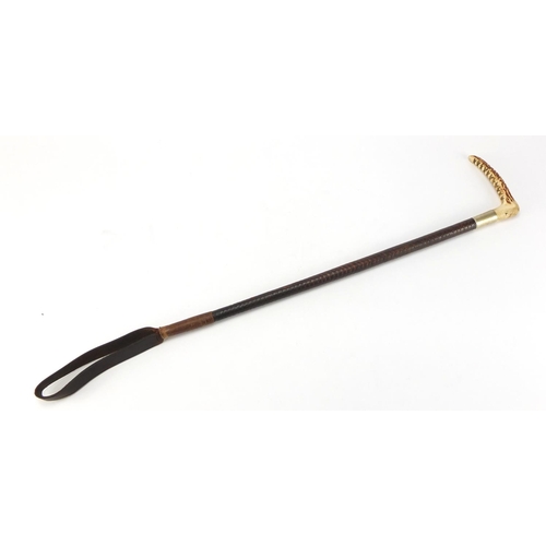503 - Horn handled riding crop with leather strap, 60cm in length