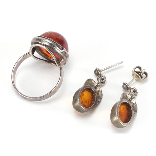 246 - Silver cabochon amber ring and a pair of earrings, the ring size P, approximate weight 8.4g