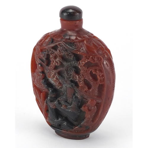461 - Chinese rhino horn style snuff bottle, decorated with figures gathering around a table, 10cm high