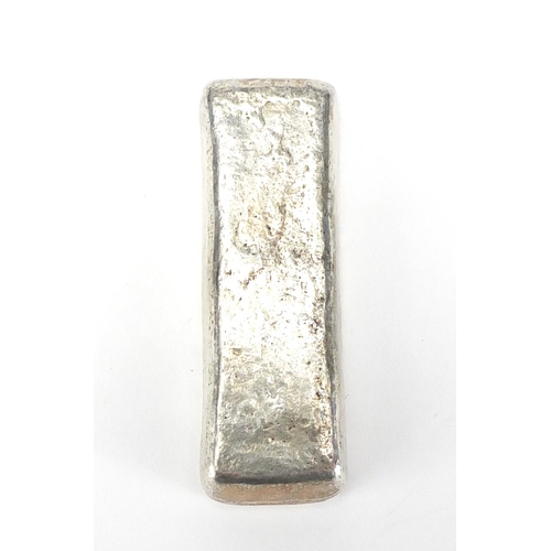 475 - Chinese silver coloured metal scroll weight, 8cm wide, approximate weight 168.8g