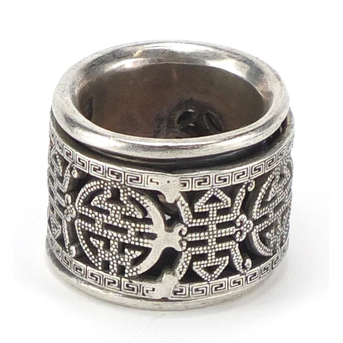 464 - Chinese silver coloured metal ring with rotating band, approximate weight 36.2g