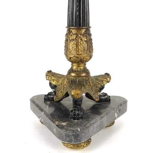 2160 - Ornate gilt candlestick with lion paw feet, raised on a triangular marble base, overall 37.5cm high