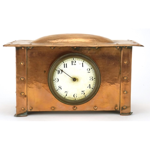 567B - Arts & Crafts beaten copper mantel clock with enamelled dial and Arabic numerals, 15cm high x 26.5cm... 