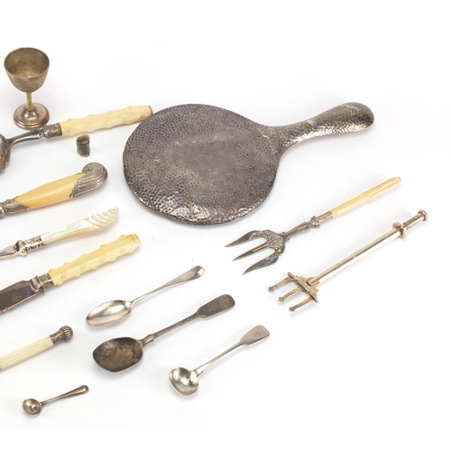293 - Silver and white metal cutlery and a silver backed hand mirror, some with ivory handles
