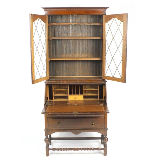 1 - Oak bureau bookcase fitted with a pair of leaded glass doors enclosing three shelves above a fall, w... 