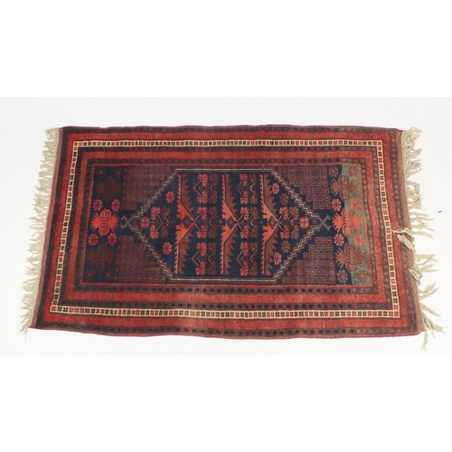 9 - Persian rug with all over geometric design onto a predominantly blue and red ground, approximately 1... 