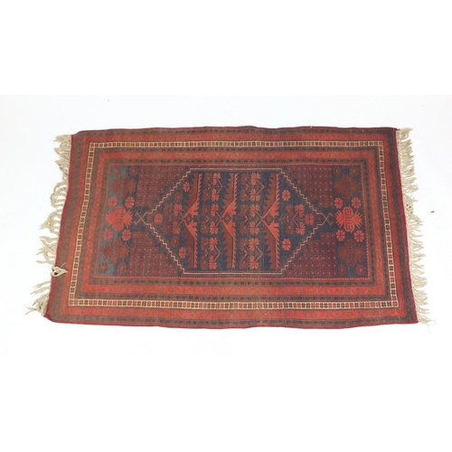 9 - Persian rug with all over geometric design onto a predominantly blue and red ground, approximately 1... 