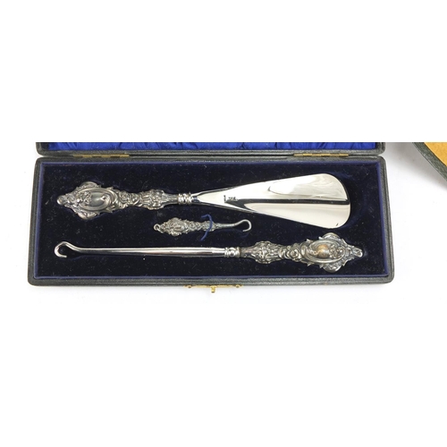 501 - Silver handled button hook and shoe horn set together with a vanity set