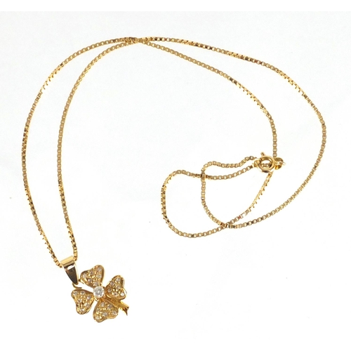 660 - Unmarked gold diamond four leaf clover pedant on an 18ct gold necklace, the pendant 2.5cm in length,... 