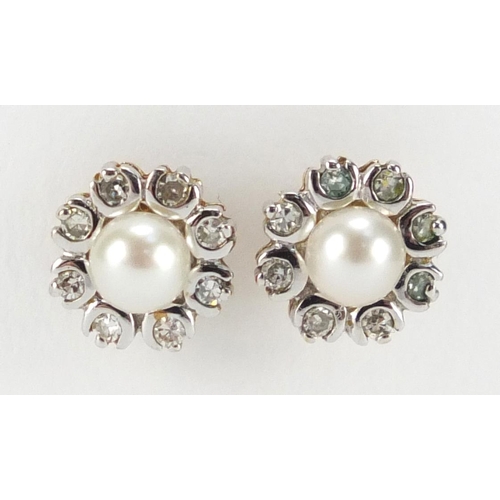 709 - Pair of unmarked gold pearl and diamond flower head earrings, 7mm in diameter, approximate weight 1.... 