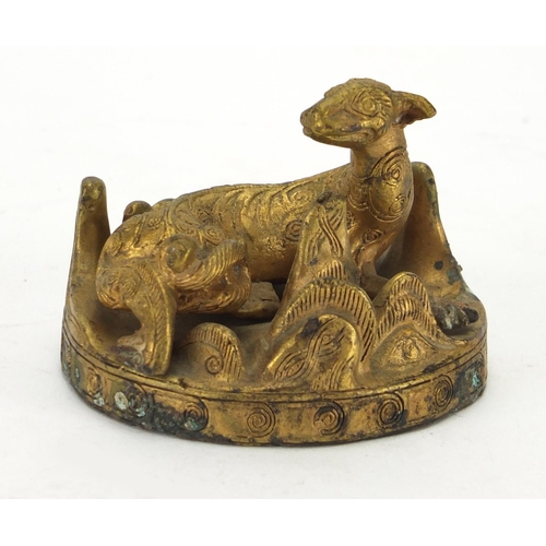 497 - Middle Eastern gilt metal figure of a mythical creature, 6cm in diameter