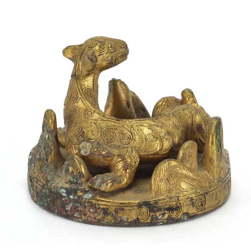 497 - Middle Eastern gilt metal figure of a mythical creature, 6cm in diameter
