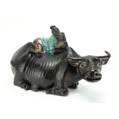 592 - Large Chinese porcelain model of a boy and water buffalo, 39cm wide