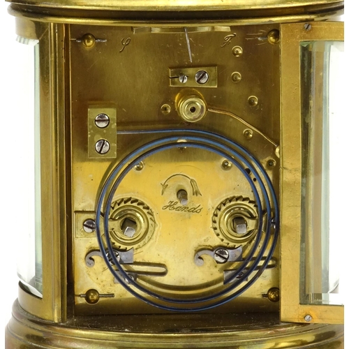 815 - 19th century oval brass cased carriage clock striking on a gong, with bevelled glass, enamelled dial... 
