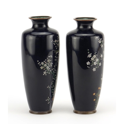 321 - Pair of Japanese cloisonné vases enamelled with birds amongst trees and flowers, each 18cm high
