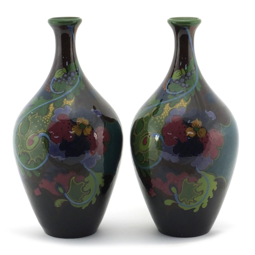 537 - Pair of Dutch art pottery vases by Gouda, hand painted with stylised flowers, painted marks to the b... 