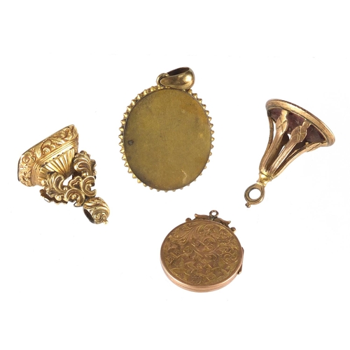 745 - Two Victorian gilt metal intaglio seal fobs, a mourning locket and porcelain portrait pendant, the l... 
