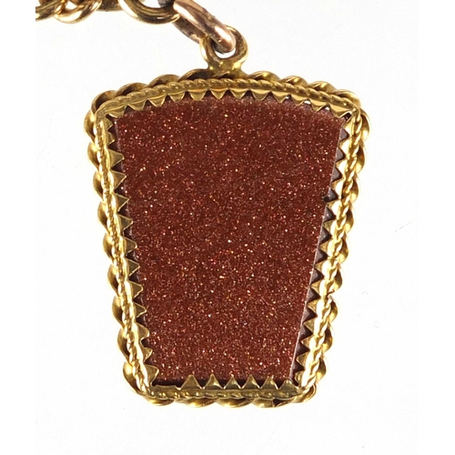669 - 9ct gold watch chain with T-bar and red sandstone pendant, 44cm in length, approximate weight 48.5g