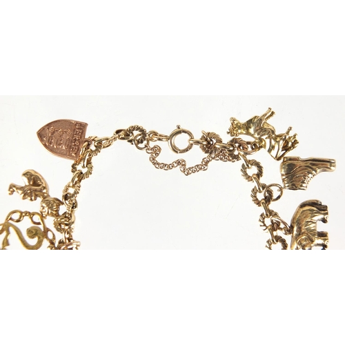 705 - 9ct gold charm bracelet with a selection of mostly gold charms including church, Dutch figure, pixie... 