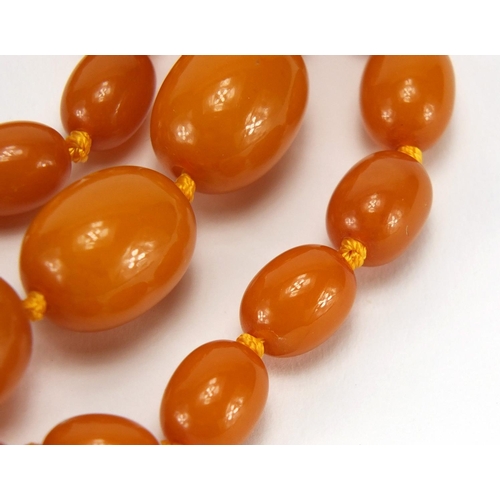 763 - Amber coloured bead necklace, 64cm in length, approximate weight 32.0g