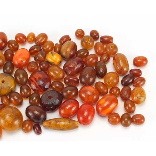 771 - Loose amber coloured beads, approximate weight 68.0g