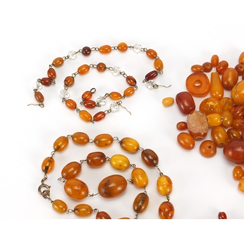 762 - Loose amber coloured beads, the largest 2cm in length, approximate weight 88.2g