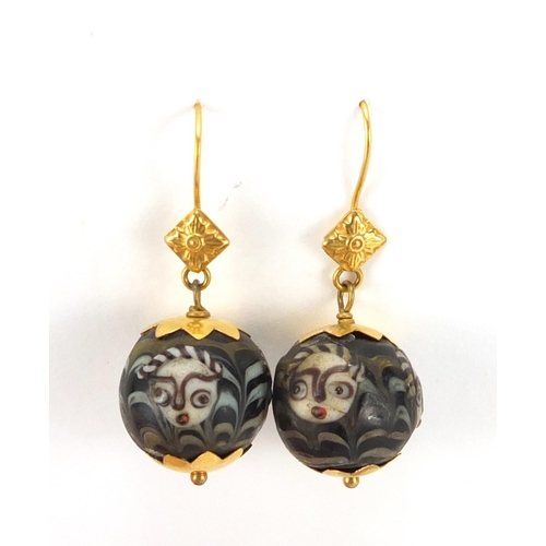 728 - Pair of continental unmarked gold drop earrings, hand painted with face masks, 4cm in  length, appro... 