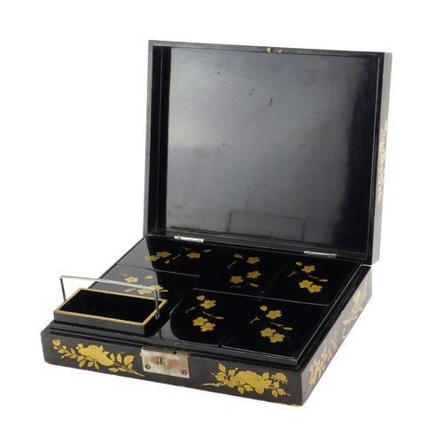 363 - Chinese black lacquer box, the hinged lid gilded with a landscape opening to reveal six boxes gilded... 