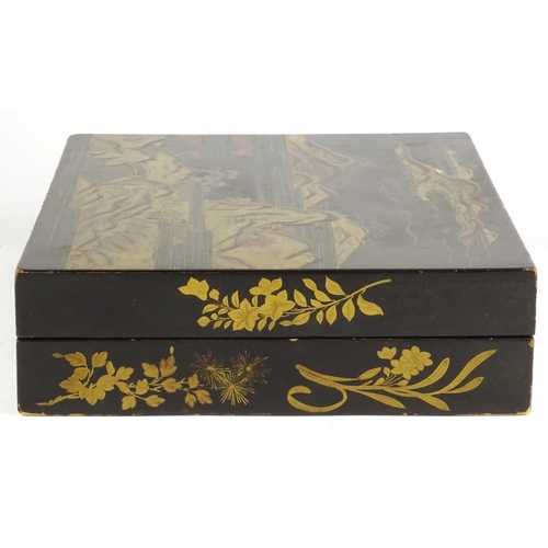 363 - Chinese black lacquer box, the hinged lid gilded with a landscape opening to reveal six boxes gilded... 