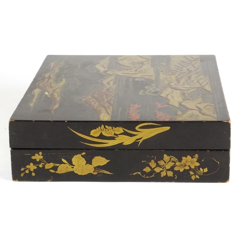 363 - Chinese black lacquer box, the hinged lid gilded with a landscape opening to reveal six boxes gilded... 