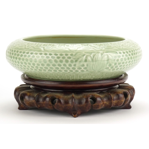 306 - Chinese celadon glazed squatted bowl, raised on a carved wood stand, six figure character marks to t... 