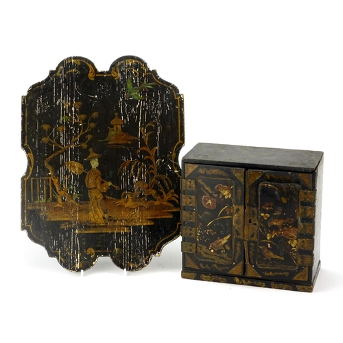 2109 - Japanese black lacquered table cabinet and a Chinese lacquered panel gilded with a figure before wat... 