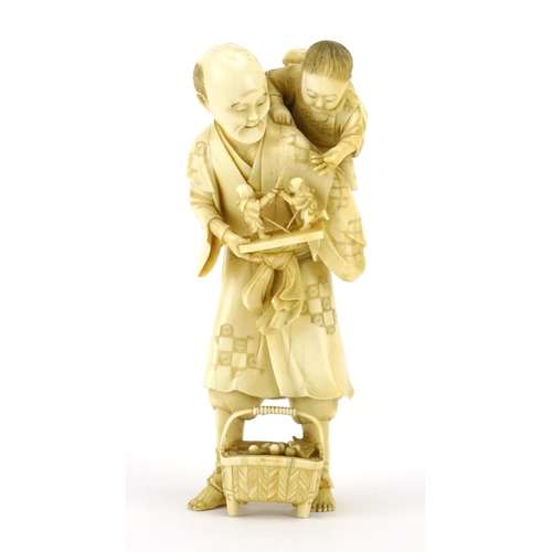 348 - Good Japanese Meiji period carved ivory okimono of a father and child, the father holding a diorama ... 