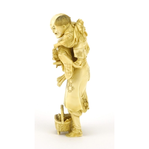 348 - Good Japanese Meiji period carved ivory okimono of a father and child, the father holding a diorama ... 