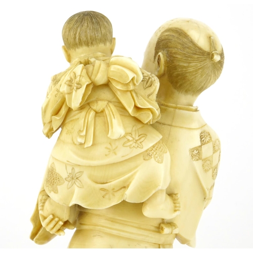 348 - Good Japanese Meiji period carved ivory okimono of a father and child, the father holding a diorama ... 