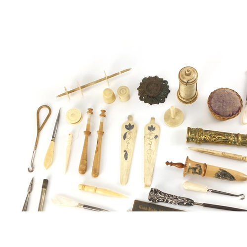 487 - Antique and later sewing items including a treen needle case, wicker basket, pin cushion and bone ne... 