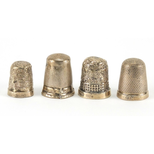 309 - Four silver thimbles two with floral decoration, the largest 2.1cm high, approximate weight 13.2g