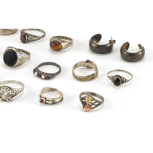 206 - Twelve silver and white metal rings and a pair of earrings, some set with colourful stones, approxim... 