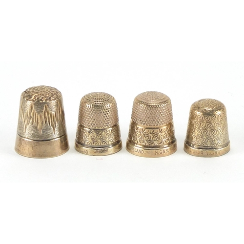326 - Four silver thimbles, three with engraved decoration, the largest 2.1cm high, approximate weight 13.... 