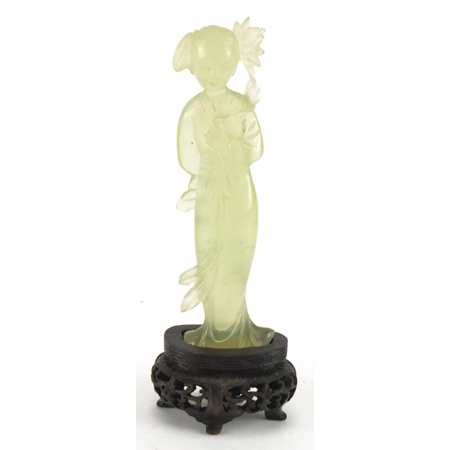 587 - Chinese jadeite figure on a carved hardwood base, 13cm high, with fitted box
