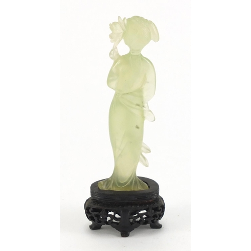 587 - Chinese jadeite figure on a carved hardwood base, 13cm high, with fitted box