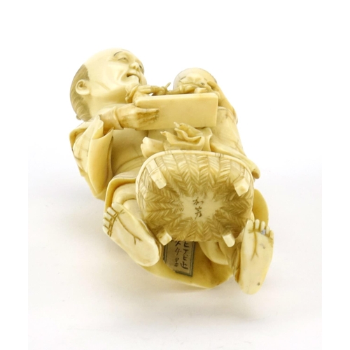 348 - Good Japanese Meiji period carved ivory okimono of a father and child, the father holding a diorama ... 