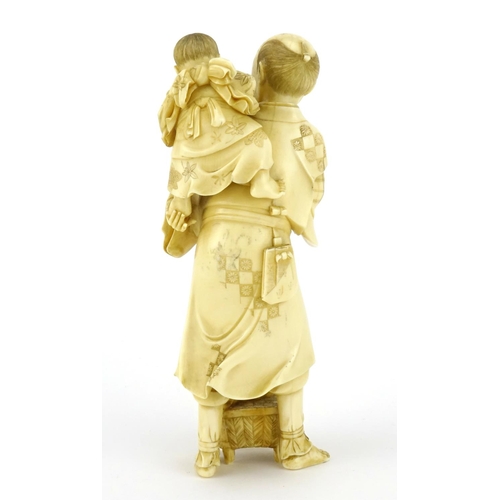 348 - Good Japanese Meiji period carved ivory okimono of a father and child, the father holding a diorama ... 