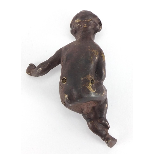 451 - Bronzed figure of a seated child, 8cm in length