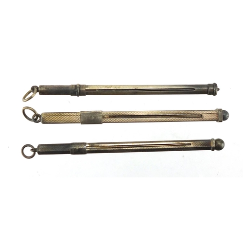 2525 - Three silver swizzle sticks, two with engine turned decoration, the largest 9cm in length (when clos... 