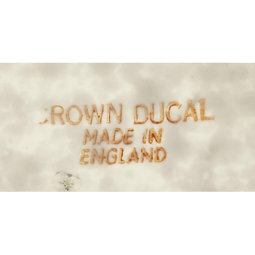 528 - Crown Ducal pottery wall plaque by Charlotte Rhead, hand painted and tube lined with stylised flower... 