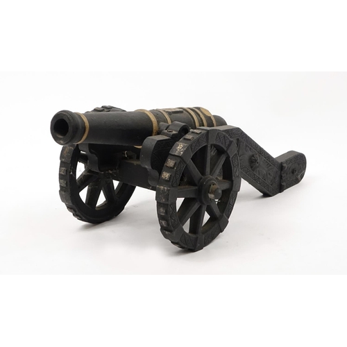 2094 - Hand painted cast iron model cannon with stand, 75cm in length