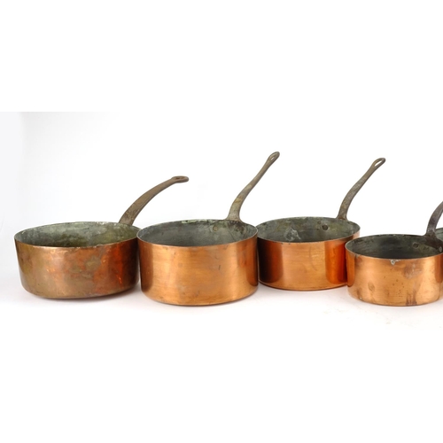 2389 - Graduated set of eight copper and wrought iron saucepans, the largest 44.5cm in length