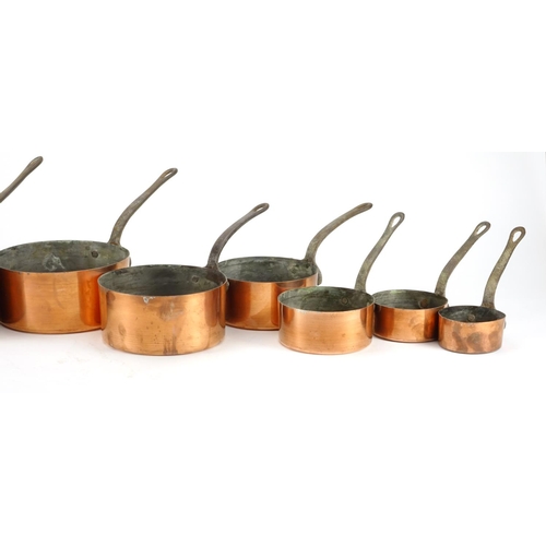 2389 - Graduated set of eight copper and wrought iron saucepans, the largest 44.5cm in length